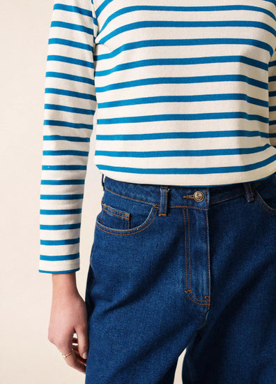 Person trägt die Meridien Moderne Marinière von SAINT JAMES in Blau-Weiß, von Schultern bis Hüfte gezeigt.